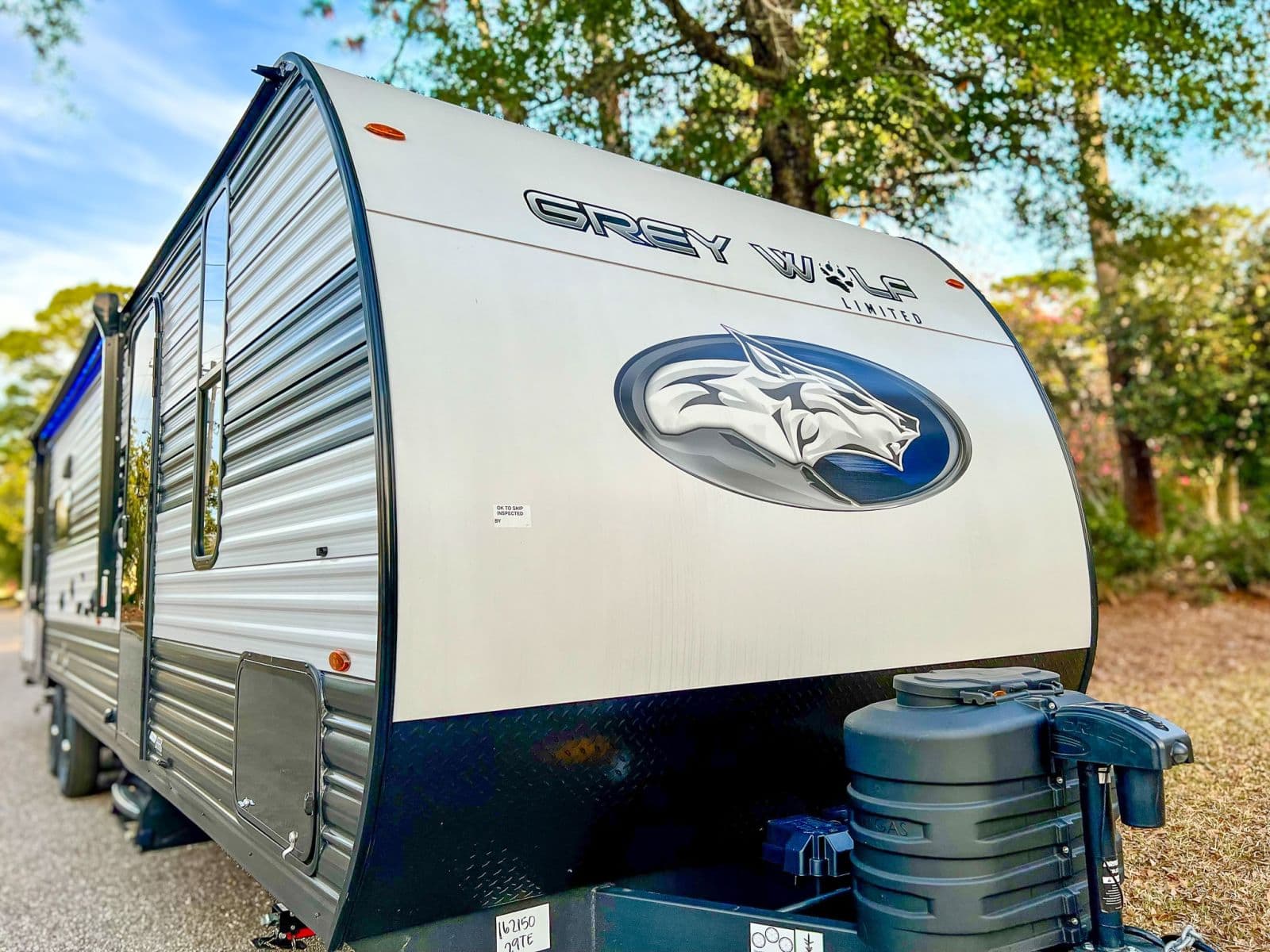 Grey Wolf Limited travel trailer, featuring its wolf logo, available for rv rental. Perfect for your next camping trip in the outdoors.