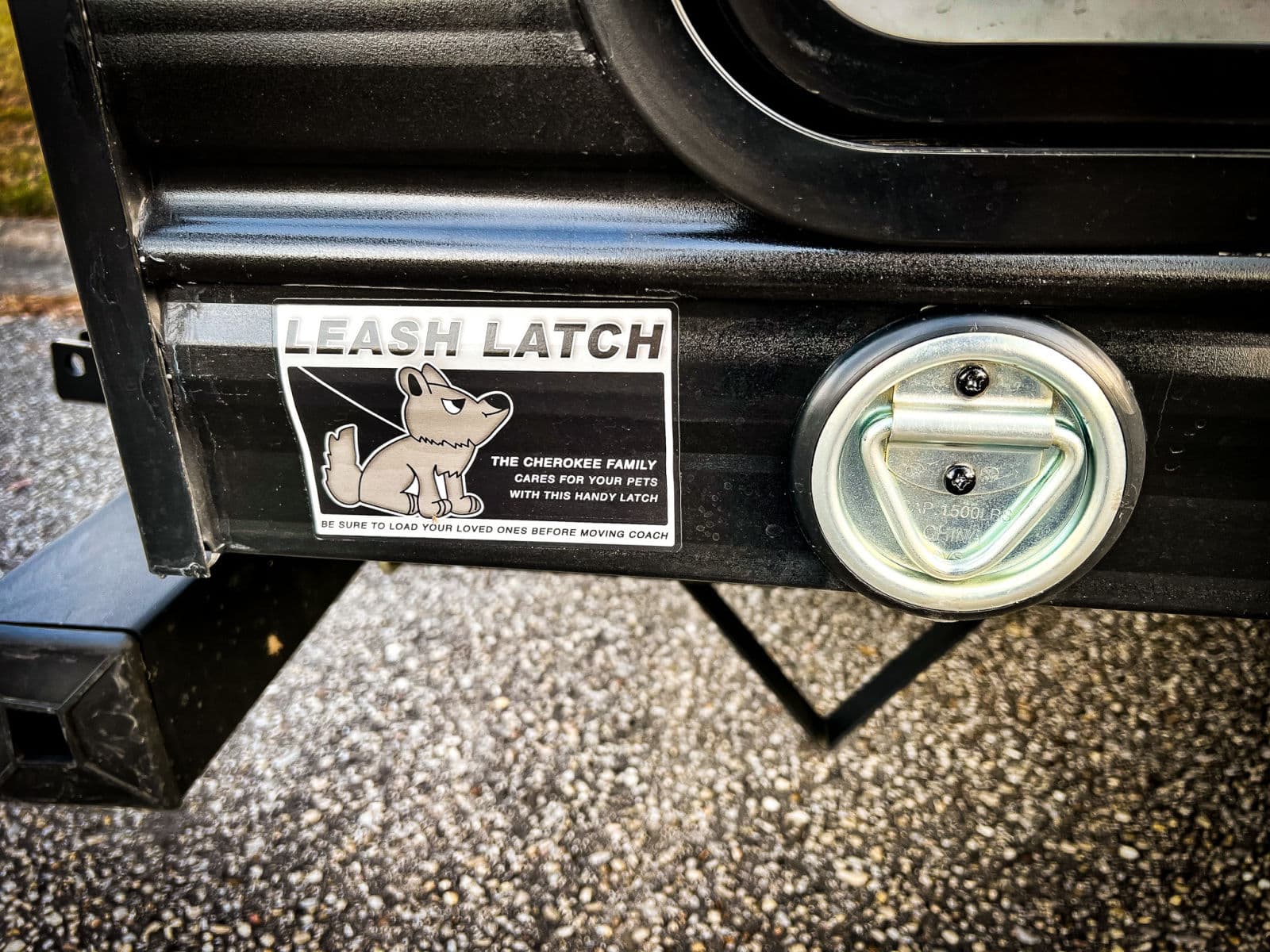 RV rental shows a "Leash Latch" sticker with a cartoon dog and D-ring for pet safety on the travel trailer side.